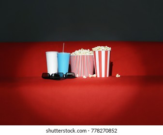 Popcorn And Drinks On Red Sofa In Home Cinema. Movie Night