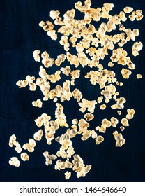 Popcorn dropping from top to bottom in front of blue textured backdrop