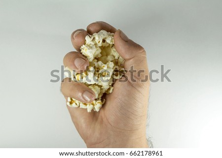 Similar – woman with popcorn in hand on yellow background. Copyspace