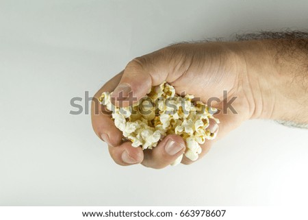 Similar – woman with popcorn in hand on yellow background. Copyspace