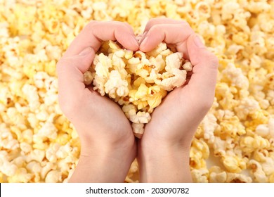 Popcorn in hands, close-up