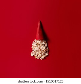 Popcorn in an ice cream cone on a red background. Christmas concept, top view. Flat layer