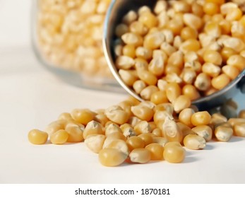 popcorn kernels spilling out of measuring cup