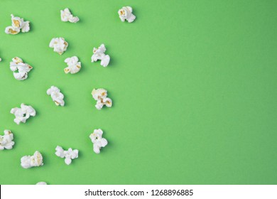 Popcorn lies evenly distributed on a colored surface - concept with a background consisting of popcorn which lies at a certain distance from each other on the surface - Shutterstock ID 1268896885