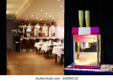 Popcorn Machine In Background Of Restaurant And Bar In Movie Theater. Shallow Depth Of Field.