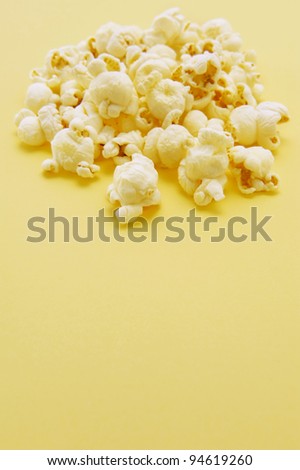 Similar – woman with popcorn in hand on yellow background. Copyspace