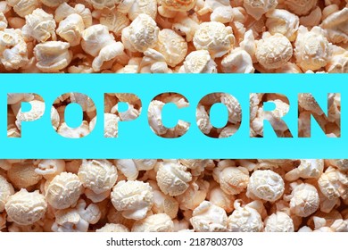 Popcorn texture background with inscription POPCORN. Word POPCORN on blue background. Cinema poster concept.