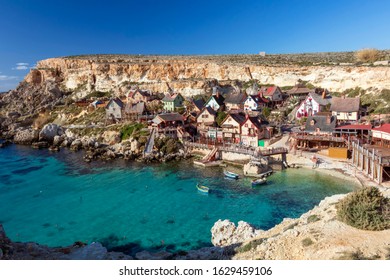 Popeye Village, Malta – January, 2020: panoramic view of Sweethaven film set village converted into a small attraction fun park, with collection of rustic and ramshackle wooden buildings in Anchor Bay