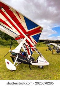 Popham, near Basingstoke, England - August 2021: Microlight aircraft with Union Jack flag pattern on the sail wing it was builtt by P M Aviation Quik GTR.