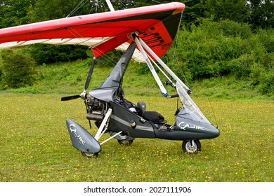 Popham, near Basingstoke, England - August 2021: Twin seat microlight aircraft parked on the side of the grass airfield