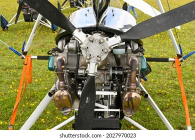 Popham, near Basingstoke, England - August 2021: Close up view of the propeller and rotary engine of a microlight aircraft.