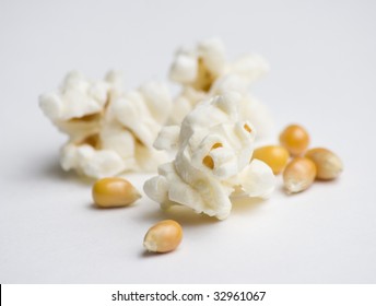 Popped and unpopped popcorn on white