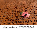 Poppy casting a shadow over some of the 57000 names who lost their lives during WW2 defending England as part of bomber command seen at Bomber Command Centre, Lincoln in June 2021.