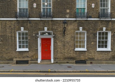 Poppy Colored Door Next To Two White Sale, Central London, UK - 07 Oct 2022