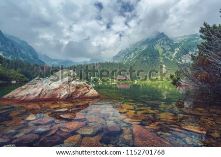 Popradske pleso in the High Tatras Mountains, Slovakia. Charming High Tatras with a forest on the slopes of the mountains and a hotel on the shore of the lake.