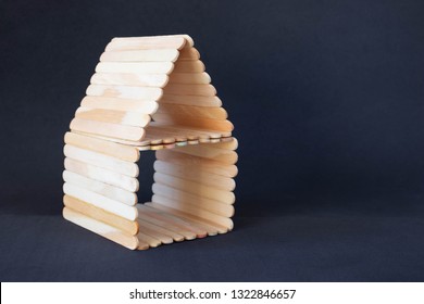 Popsicle Stick House On A Black Background