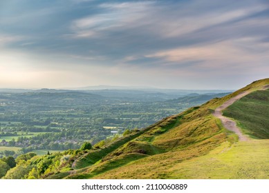 Popular beauty spot and landmark,lsoon after dawn,with amazing views of surrounding counties in central England.Summer sunlight clipping the ridges of the Malvern peaks and ridges.
