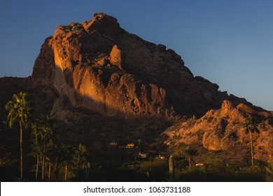 Popular Camelback Mountain with patches of sunlight cast upon the peak at sunrise, Paradise Valley, Arizona