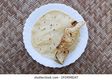 Popular Indian Savoury Snack Eaten With Lunch Dinner Or Just Snacks. Papad Or Pappadoms. Both Roasted And Deep Fried Papads Served In White Plate