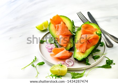 Popular keto diet : salmon and avocado  with arugula and lime. healthy lunch. ketogenic diet  food