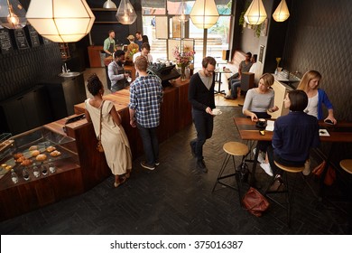 Popular modern coffee shop busy with customers and staff - Powered by Shutterstock