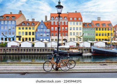 The popular Nyhavn area at Copenhagen, Denmark, with a street light and bicycles in front of the colorful houses