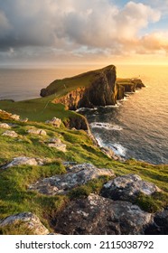 Popular sightseeing destination Neist Point Lighthouse on the beautiful Isle of Skye, Scotland, UK. Scottish coastal landscapes with golden evening light.