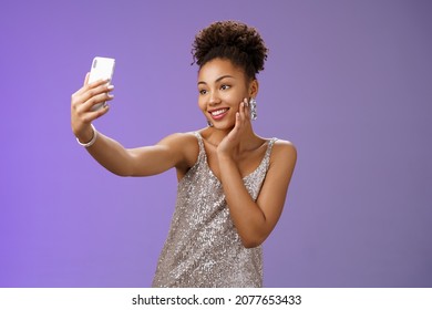 Popular Stylish African-american Female Blogger Take Selfie Partying Night Club Extend Arm Holding Smartphone Posing Looking Phone Display Gladly Grinning Standing Blue Background In Elegant Dress