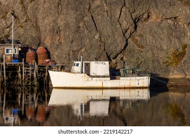 A popular tourist destination in the St. John's area is Quidi Vidi, a quaint fishing village located on a narrow, sheltered harbour.  This image focuses on a moored fishing boat during sunset.