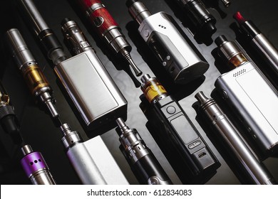 Popular vaping device mod.Upgrade parts for modern vaporizer e-cig device,spare parts.New device model,micro coil clearomizer.Quit smoking nicotine cigarette,start vaping safe ecig vape - Shutterstock ID 612834083