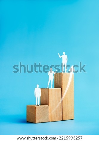 Population increase, people evolution chart, leadership concept. Rise up arrows and human icon standing on a growth graph chart steps arranged by wood cube blocks on blue background, vertical style.