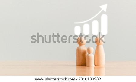 Population increasing graph and wooden toy block on table top background. People lifestyle and family statistics concept.