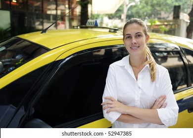 porait of a proud female taxi driver with her new cab