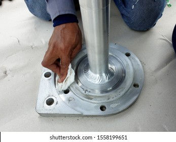 Porcelain Bushing Of 115 KV Hybrid Switchgear: Electrical Supervisor Cleaning The Point Of Gas Leakage (SF6) Area Of Terminal Pad Mounting Plates.