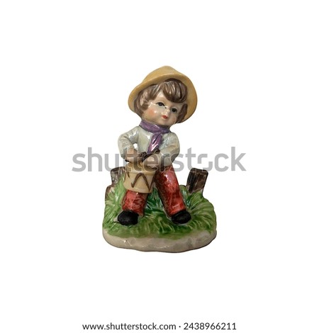 Porcelain ceramic figures, boy playing the drum isolated on white background. Painted collectibles vintage antiques art decor using for interior.