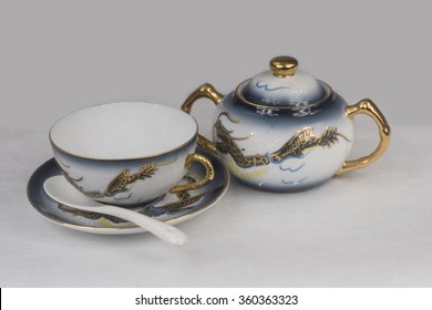 Porcelain cup and sugar bowl. White and blue porcelain Chinese. Gold blue dragons.