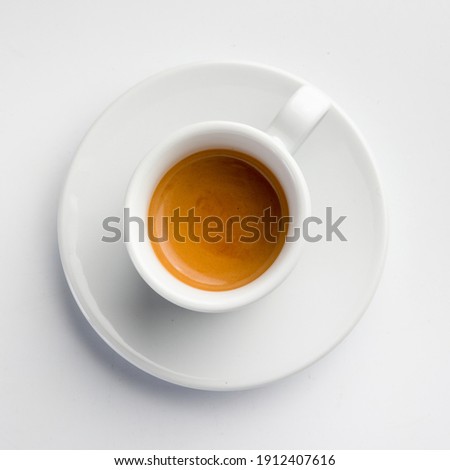 porcelain espresso coffee cup with saucer on white background. top view