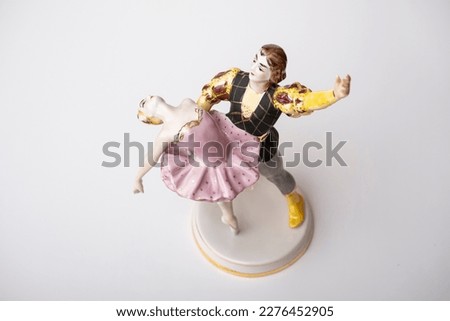Porcelain figurine, a pair of dancing ballerinas on a white background.