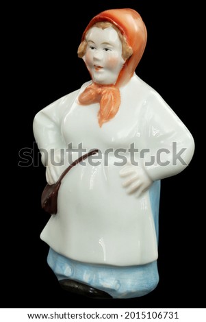 Porcelain figurine of a woman, the fisherman's wife, isolated on black background