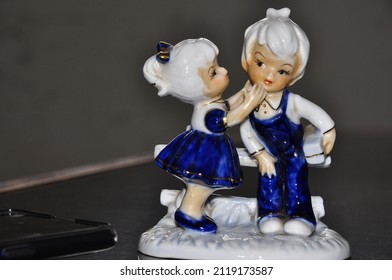 Porcelain Figurines Of Kissing Boy And Girl.