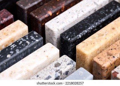 Porcelain stoneware square samples laid on kitchen countertop as examples of future kitchen fasade exterior. Samples slabs of natural granite marble quartz for stone countertops close up diagonal. - Shutterstock ID 2218028257
