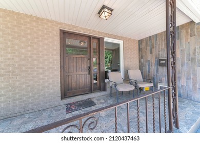 Porch Of House With Concrete Floors And Two Lounge Chairs