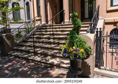 The porch of the house in the style of Old England, decorated with a pot of flowers. Typical Porch Decoration in Historic Boston, Massachusetts