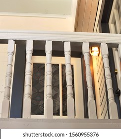 Porch Light Illuminates The Balcony Of A Quaint Vintage Building