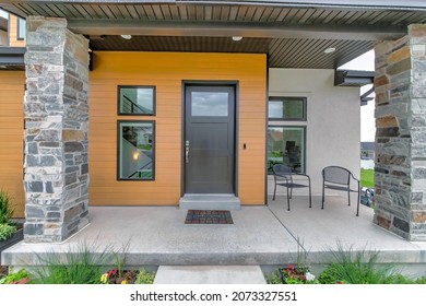Porch of a modern house with wood and concrete sidings - Shutterstock ID 2073327551
