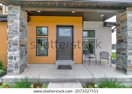 Porch of a modern house with wood and concrete sidings