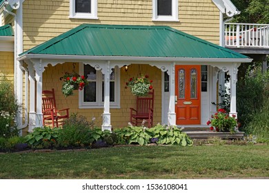 Porch Of Old Clapboard House With Rocking Chairs