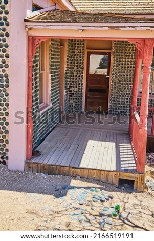 Porch of unique bottle house in desert ghost town