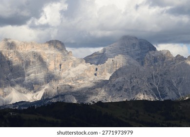 Pordoi massif cliffs with dramatic cloud shadows