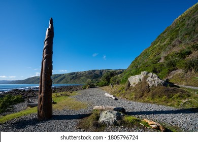 Porirua / New Zealand - July 26 2020: Maori Carving Pou Tangaroa Standing In Pukerua Bay